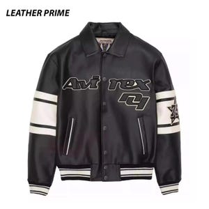 May include: A black leather jacket with a collar, snap-button front closure, and white stripes on the sleeves. The chest features the text "Avirex" and "75" in white and black lettering. The cuffs and hem have black and white striped ribbing.
