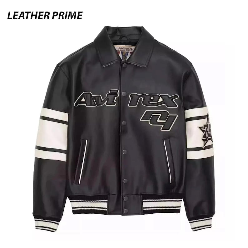 May include: A black leather jacket with a collar, snap-button front closure, and white stripes on the sleeves. The chest features the text "Avirex" and "75" in white and black lettering. The cuffs and hem have black and white striped ribbing.