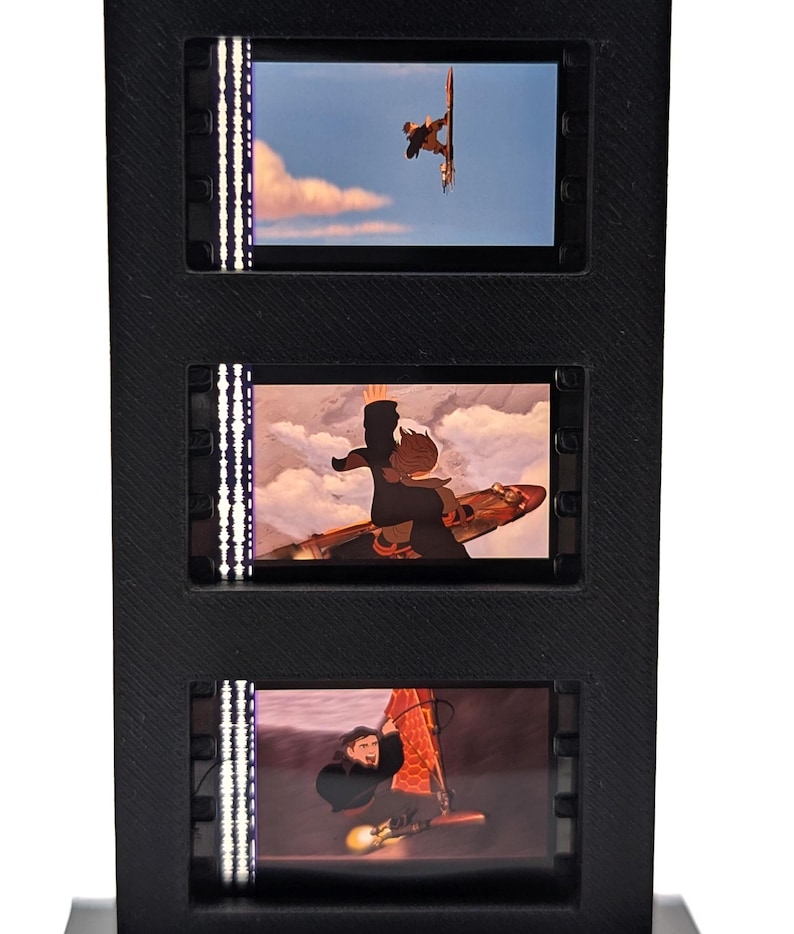 May include: A black, three-tiered display featuring three illuminated panels with animated scenes of a person windsurfing. The panels are framed in black and have vertical LED lights on the sides.