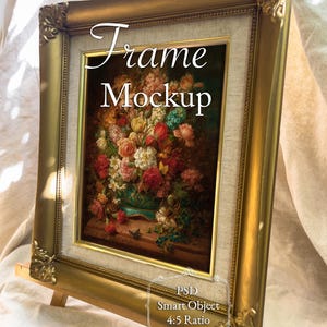 May include: A gold-colored framed artwork on a wooden easel. The artwork features a floral still life with red, pink, and white roses. The frame has ornate corner details, and the text "Frame Mockup" is visible on the artwork.