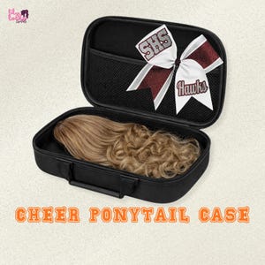 May include: Black cheer ponytail case with a brown wig inside. The case is open, revealing a mesh pocket and a cheer bow with the text "SHS" and "Hawks". The text "CHEER PONYTAIL CASE" is at the bottom.