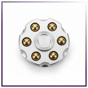 May include: A silver fidget spinner with six gold-colored ball bearings arranged around a central silver disc. The spinner has a circular design with rounded edges and a smooth, metallic finish. The background is white.