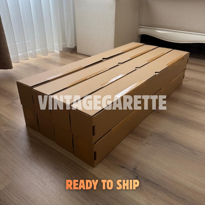 May include: A stack of rectangular brown cardboard shipping boxes arranged in a grid. The text VINTAGEGARETTE is printed in white across the centre of the boxes, and the text READY TO SHIP is printed in orange at the bottom of the image.