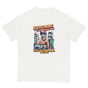 May include: White t-shirt featuring a cartoon cat mechanic wearing sunglasses and a work uniform, sitting next to a race car. The shirt has the text "EXPLODE THE PERFORMANCE" and "LET THEM KNOW WHO YOU ARE".