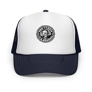 May include: A white and navy blue trucker hat with a black and white graphic of a smoking skull wearing a hat. The graphic is surrounded by the words "DON'T PANIC IT'S ORGANIC".