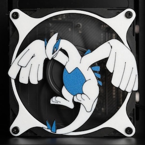 May include: A white and blue cartoon character design is mounted on a computer fan. The fan is framed by a white square with black screws. The character has outstretched wings and a blue chest.