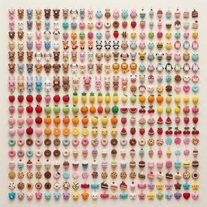 May include: A large collection of small, crocheted charms arranged in a grid. The charms feature various designs including animals like bears, cats, and pandas, as well as food items such as fruits, donuts, ice cream cones, and cakes.