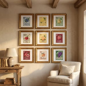 May include: Nine framed art prints with gold frames are displayed on a wall. Each print features a postage stamp design with a fruit or flower illustration and a related word like "Peace" or "Love". The prints are arranged in a grid.