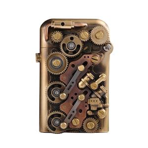May include: A steampunk-style lighter with a brass finish. The lighter features an intricate design of gears, levers, and mechanical components in shades of gold, bronze, and copper. The rectangular body has rounded edges and a textured appearance.