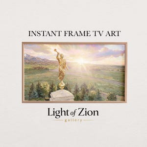 May include: A framed landscape painting featuring a golden statue atop a building, with a scenic background of mountains and fields. The artwork is set against a sunset sky. Text at the top reads "INSTANT FRAME TV ART" and at the bottom "Light of Zion gallery".
