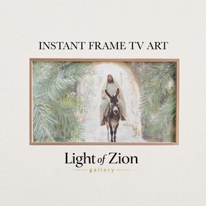 May include: A framed artwork depicting a person riding a donkey through an archway, framed by palm trees. The artwork is in a wooden frame. The text "INSTANT FRAME TV ART" is at the top, and "Light of Zion gallery" is at the bottom.