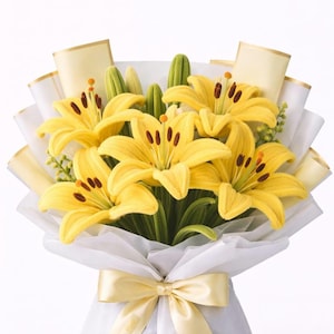 May include: A bouquet of bright yellow lily flowers crafted from fabric, featuring dark brown stamens and green stems. The flowers are wrapped in white paper with cream-colored accents and tied with a cream-colored satin ribbon at the base.