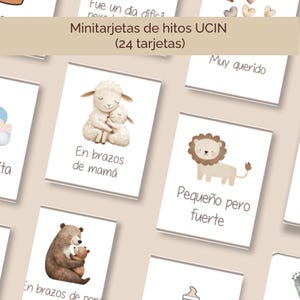 May include: A collection of milestone cards for a baby, featuring illustrations of a sheep, lion, and bear. The cards have text in Spanish, including "En brazos de mamá" and "Pequeño pero fuerte."