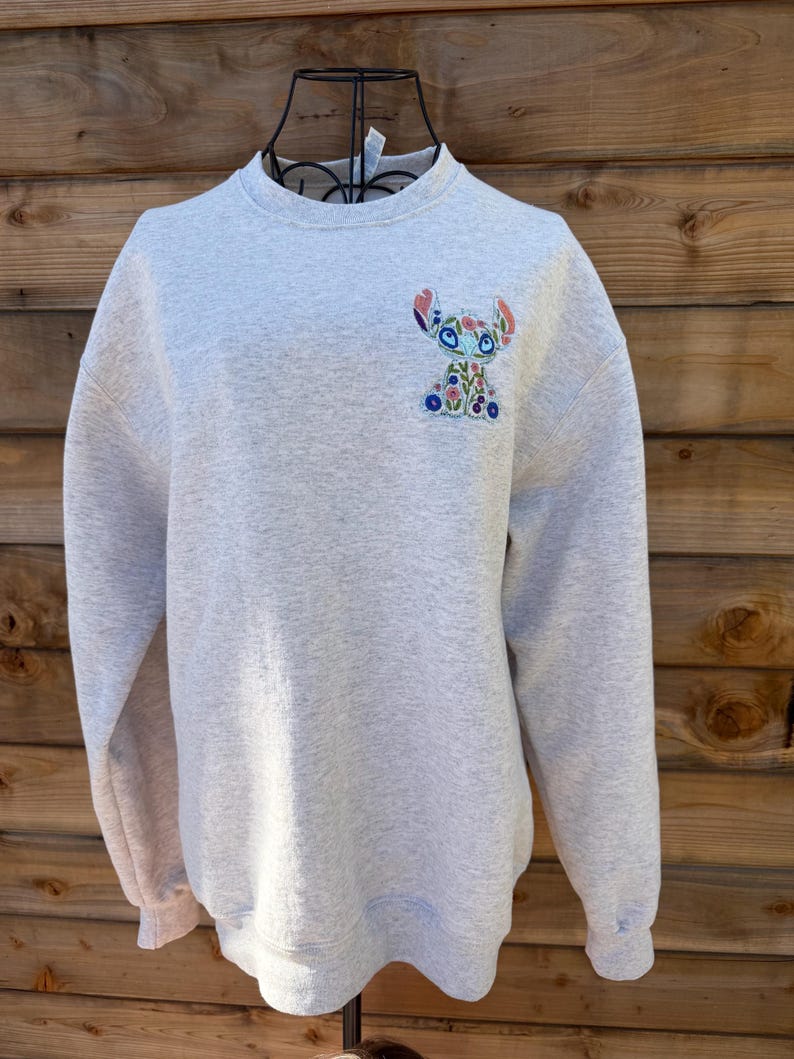 May include: A set of three ceramic mugs with a speckled, matte finish. The mugs are in shades of cream, light gray, and dark gray. Each mug has a simple, minimalist design, perfect for coffee or tea.