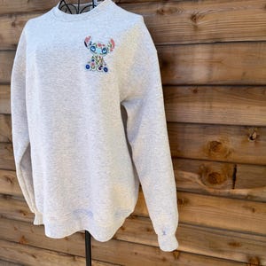 May include: A rustic wooden sign with the text "Welcome to our home" in white lettering. The sign features a distressed finish and a simple, inviting design, perfect for front door decor.