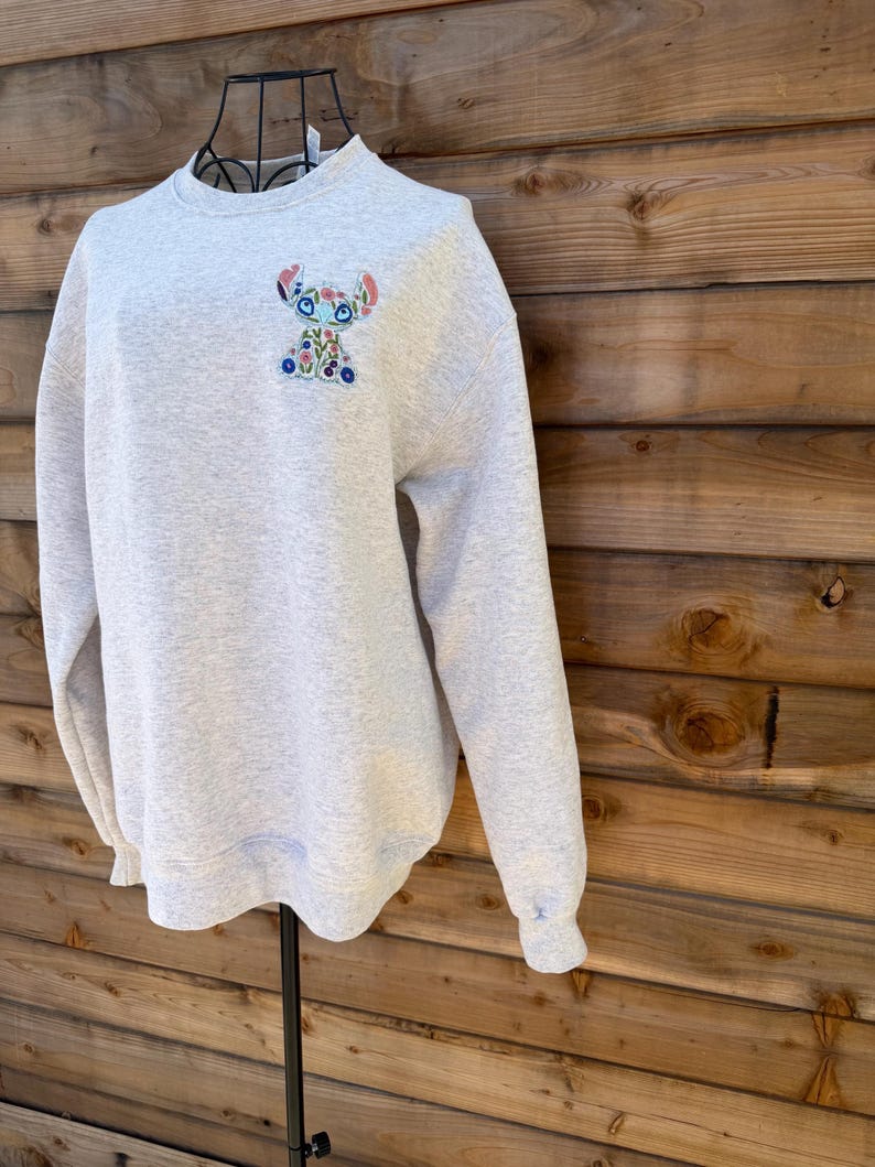 May include: A rustic wooden sign with the text "Welcome to our home" in white lettering. The sign features a distressed finish and a simple, inviting design, perfect for front door decor.