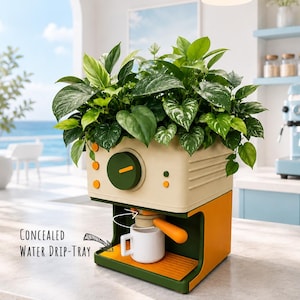 May include: A beige and green planter shaped like a coffee machine with a large green dial, orange accents, and a white mug underneath. The planter holds a lush green leafy plant. Text on the image reads: Concealed WATER DRIP-TRAY.