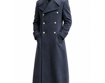 May include: A long, double-breasted charcoal grey wool coat featuring wide lapels, shoulder epaulettes, and six silver-toned buttons. The coat has a structured collar, long sleeves with cuffs, and deep side pockets, extending down to the lower calf area.