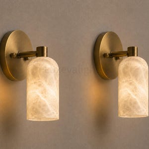 Pair of modern natural alabaster wall sconces in solid antique brass, luxury mid century wall lights for bathroom vanity, bedroom bedside, hallway and living room
Mid century modern solid brass wall sconces with glowing natural alabaster shades for elegant home lighting
Contemporary antique brass wall sconces with natural alabaster cylinder shades, luxury interior wall lighting
Modern alabaster wall sconce pair in solid brass, luxury mid century wall lighting for bedroom and bathroom vanity