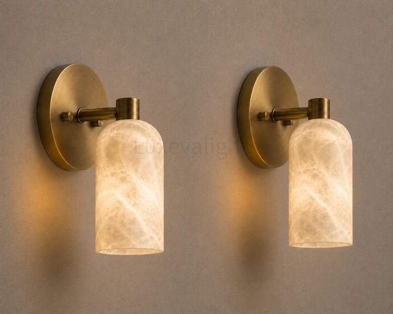 Pair of modern natural alabaster wall sconces in solid antique brass, luxury mid century wall lights for bathroom vanity, bedroom bedside, hallway and living room
Mid century modern solid brass wall sconces with glowing natural alabaster shades for elegant home lighting
Contemporary antique brass wall sconces with natural alabaster cylinder shades, luxury interior wall lighting
Modern alabaster wall sconce pair in solid brass, luxury mid century wall lighting for bedroom and bathroom vanity