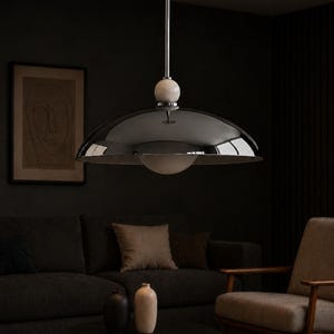 Retro futuristic chrome pendant lamp with oversized metallic dome and elegant alabaster detail for luxury interiors
Contemporary chrome hanging pendant fixture with wide dome shade, modern designer lighting for dining room and kitchen spaces
Modern chrome ceiling pendant light with alabaster sphere detail, contemporary dome hanging fixture for dining room lighting
Mid Century Modern Chrome Pendant Light, Luxury Dome Hanging Lamp, Alabaster Ball Ceiling Light, Modern Kitchen Island Lighting