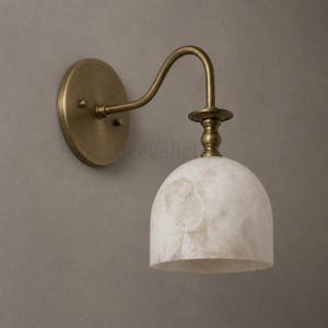 Pair of modern alabaster wall sconces with antique brass finish, handcrafted mid century bathroom vanity wall lights on a warm beige textured wall
Modern alabaster wall sconce pair in antique brass, luxury bathroom vanity wall lights with natural stone shades
Handmade brass alabaster wall sconces, mid century modern bathroom vanity lighting with warm ambient glow
Luxury antique brass wall sconces featuring natural alabaster shades, perfect for bathroom vanity or hallway lighting
brass wall light