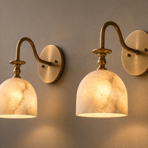 Modern brass wall light fixture with natural alabaster shade, handmade bathroom vanity sconce pair
Luxury alabaster bathroom wall sconces in antique brass, handcrafted mid century wall lighting
Natural alabaster wall sconce pair with antique brass finish, elegant modern bathroom vanity lights
Handcrafted brass and alabaster wall sconces, luxury mid century bathroom wall light fixtures
Modern bathroom vanity wall lights with alabaster shades antique brass finish, handmade brass wall sconce pair