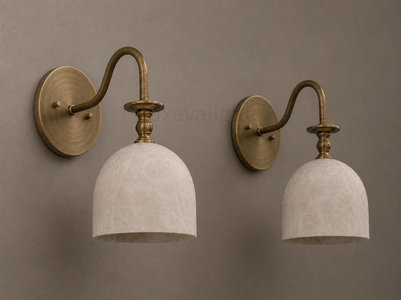 Pair of modern alabaster wall sconces with antique brass finish, handcrafted mid century bathroom vanity wall lights on a warm beige textured wall
Modern alabaster wall sconce pair in antique brass, luxury bathroom vanity wall lights with natural stone shades
Handmade brass alabaster wall sconces, mid century modern bathroom vanity lighting with warm ambient glow
Luxury antique brass wall sconces featuring natural alabaster shades, perfect for bathroom vanity or hallway lighting
brass wall light