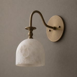 Pair of modern alabaster wall sconces with antique brass finish, handcrafted mid century bathroom vanity wall lights on a warm beige textured wall
Pair of handcrafted alabaster brass wall lights, modern mid century wall sconces for bathroom, bedroom, or entryway
Modern brass wall sconce pair with natural alabaster shades, elegant luxury bathroom vanity lighting fixture
Antique brass alabaster wall light fixture, handmade modern wall sconces with warm illumination for luxury interiors