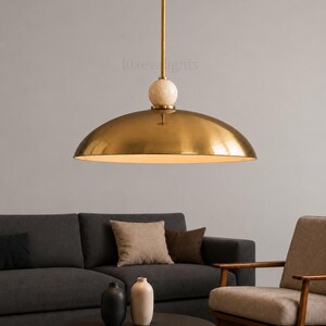 Minimalist chrome dome pendant lamp inspired by vintage Italian modern design, elegant ceiling light for modern home decor
Handmade chrome dome hanging light with warm ambient glow, mid century modern kitchen island lighting fixture
Large polished chrome pendant light with sleek dome shade and alabaster ball accent, luxury modern ceiling fixture
Scandinavian modern chrome dome ceiling light with minimalist hanging rod and soft warm interior lighting aesthetic
Retro futuristic chrome pendant lamp