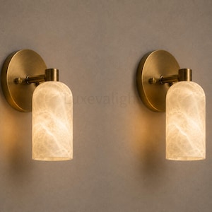 Pair of modern natural alabaster wall sconces in solid antique brass, luxury mid century wall lights for bathroom vanity, bedroom bedside, hallway and living room
Mid century modern solid brass wall sconces with glowing natural alabaster shades for elegant home lighting
Contemporary antique brass wall sconces with natural alabaster cylinder shades, luxury interior wall lighting
Modern alabaster wall sconce pair in solid brass, luxury mid century wall lighting for bedroom and bathroom vanity