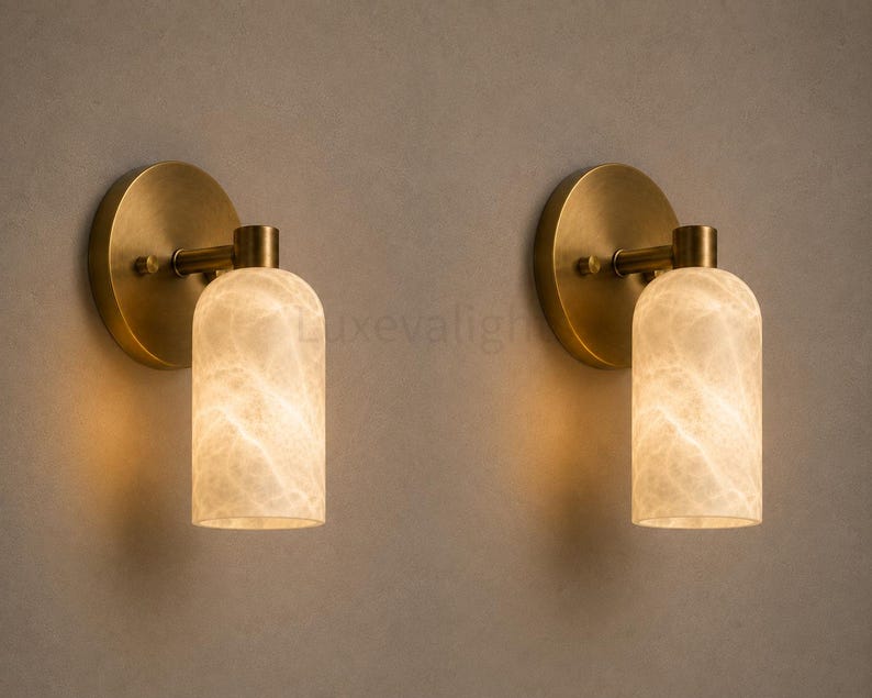 Pair of modern natural alabaster wall sconces in solid antique brass, luxury mid century wall lights for bathroom vanity, bedroom bedside, hallway and living room
Mid century modern solid brass wall sconces with glowing natural alabaster shades for elegant home lighting
Contemporary antique brass wall sconces with natural alabaster cylinder shades, luxury interior wall lighting
Modern alabaster wall sconce pair in solid brass, luxury mid century wall lighting for bedroom and bathroom vanity