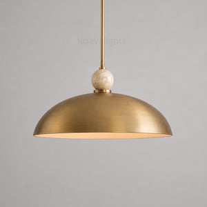 Minimalist chrome dome pendant lamp inspired by vintage Italian modern design, elegant ceiling light for modern home decor
Handmade chrome dome hanging light with warm ambient glow, mid century modern kitchen island lighting fixture
Large polished chrome pendant light with sleek dome shade and alabaster ball accent, luxury modern ceiling fixture
Scandinavian modern chrome dome ceiling light with minimalist hanging rod and soft warm interior lighting aesthetic
Retro futuristic chrome pendant lamp