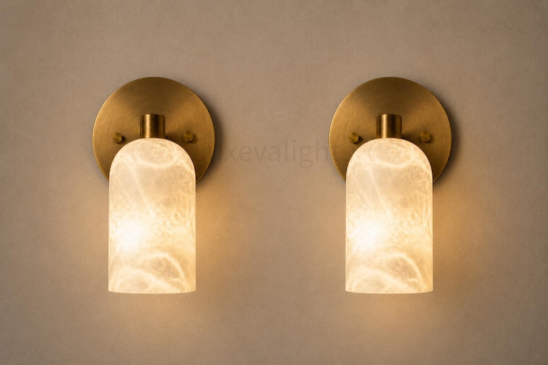 Pair of modern natural alabaster wall sconces in solid antique brass, luxury mid century wall lights for bathroom vanity, bedroom bedside, hallway and living room
Modern antique brass alabaster wall sconce pair with warm lighting for luxury bathroom vanity and bedroom decor
Handmade solid antique brass wall sconces with natural alabaster shades, modern mid century wall lighting
Luxury natural alabaster wall light pair in antique brass finish for bathroom vanity, bedside and hallway lighting