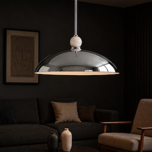 Minimalist chrome dome pendant lamp inspired by vintage Italian modern design, elegant ceiling light for modern home decor
Handmade chrome dome hanging light with warm ambient glow, mid century modern kitchen island lighting fixture
Large polished chrome pendant light with sleek dome shade and alabaster ball accent, luxury modern ceiling fixture
Scandinavian modern chrome dome ceiling light with minimalist hanging rod and soft warm interior lighting aesthetic
Retro futuristic chrome pendant lamp