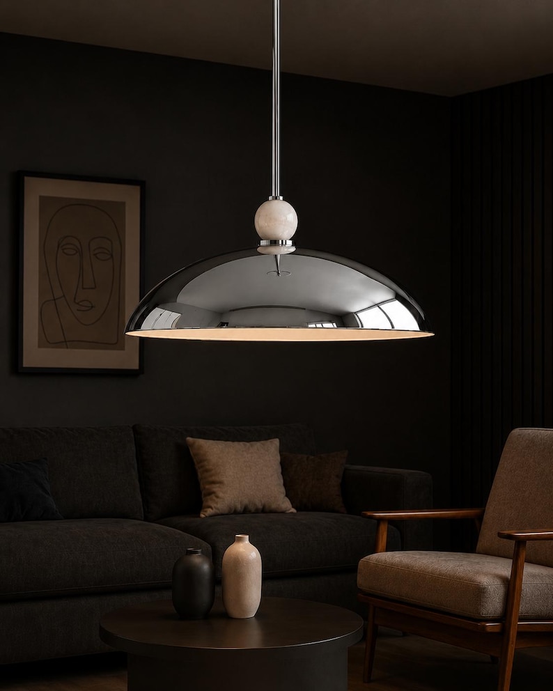Minimalist chrome dome pendant lamp inspired by vintage Italian modern design, elegant ceiling light for modern home decor
Handmade chrome dome hanging light with warm ambient glow, mid century modern kitchen island lighting fixture
Large polished chrome pendant light with sleek dome shade and alabaster ball accent, luxury modern ceiling fixture
Scandinavian modern chrome dome ceiling light with minimalist hanging rod and soft warm interior lighting aesthetic
Retro futuristic chrome pendant lamp
