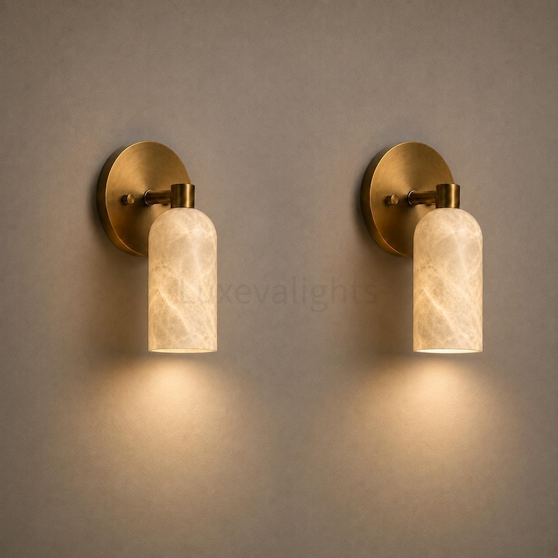 Natural alabaster cylinder wall sconces in antique brass, designer lighting for bedroom, hallway and living room
Minimalist antique brass wall sconces with glowing alabaster shades for modern home decor
Contemporary solid brass alabaster wall light pair for luxury bathroom vanity and bedside lighting
Elegant natural alabaster wall sconces with antique brass backplate, handcrafted modern wall lighting
Premium antique brass wall sconces with natural alabaster shades for luxury interior lighting