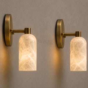 Pair of modern natural alabaster wall sconces in solid antique brass, luxury mid century wall lights for bathroom vanity, bedroom bedside, hallway and living room
Modern antique brass alabaster wall sconce pair with warm lighting for luxury bathroom vanity and bedroom decor
Handmade solid antique brass wall sconces with natural alabaster shades, modern mid century wall lighting
Luxury natural alabaster wall light pair in antique brass finish for bathroom vanity, bedside and hallway lighting