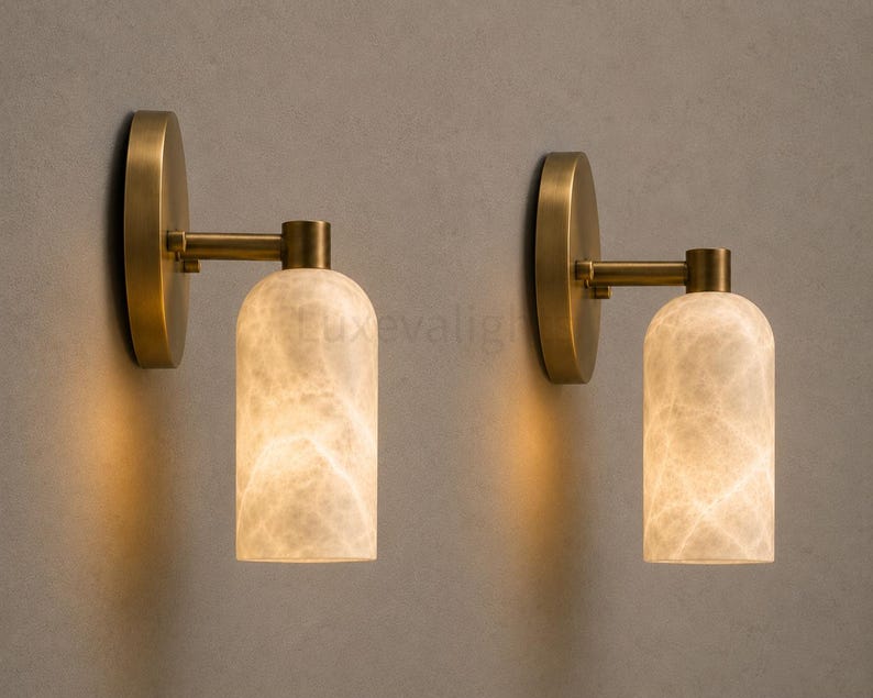 Pair of modern natural alabaster wall sconces in solid antique brass, luxury mid century wall lights for bathroom vanity, bedroom bedside, hallway and living room
Modern antique brass alabaster wall sconce pair with warm lighting for luxury bathroom vanity and bedroom decor
Handmade solid antique brass wall sconces with natural alabaster shades, modern mid century wall lighting
Luxury natural alabaster wall light pair in antique brass finish for bathroom vanity, bedside and hallway lighting