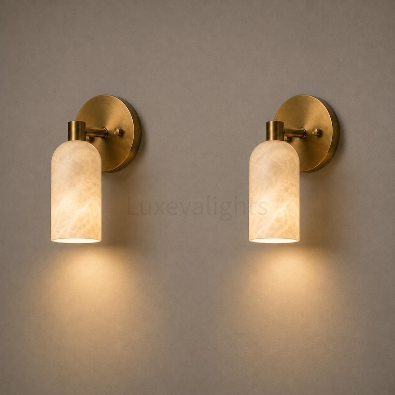 Pair of modern natural alabaster wall sconces in solid antique brass, luxury mid century wall lights for bathroom vanity, bedroom bedside, hallway and living room
Modern antique brass alabaster wall sconce pair with warm lighting for luxury bathroom vanity and bedroom decor
Handmade solid antique brass wall sconces with natural alabaster shades, modern mid century wall lighting
Luxury natural alabaster wall light pair in antique brass finish for bathroom vanity, bedside and hallway lighting