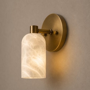 Pair of modern natural alabaster wall sconces in solid antique brass, luxury mid century wall lights for bathroom vanity, bedroom bedside, hallway and living room
Modern antique brass alabaster wall sconce pair with warm lighting for luxury bathroom vanity and bedroom decor
Handmade solid antique brass wall sconces with natural alabaster shades, modern mid century wall lighting
Luxury natural alabaster wall light pair in antique brass finish for bathroom vanity, bedside and hallway lighting