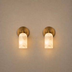 Pair of modern natural alabaster wall sconces in solid antique brass, luxury mid century wall lights for bathroom vanity, bedroom bedside, hallway and living room
Mid century modern solid brass wall sconces with glowing natural alabaster shades for elegant home lighting
Contemporary antique brass wall sconces with natural alabaster cylinder shades, luxury interior wall lighting
Modern alabaster wall sconce pair in solid brass, luxury mid century wall lighting for bedroom and bathroom vanity