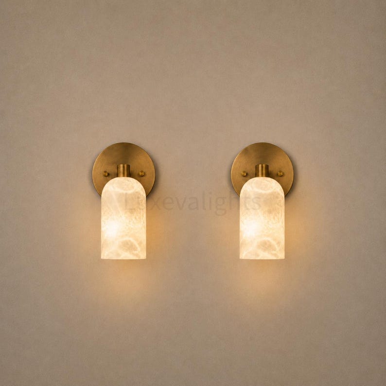 Pair of modern natural alabaster wall sconces in solid antique brass, luxury mid century wall lights for bathroom vanity, bedroom bedside, hallway and living room
Mid century modern solid brass wall sconces with glowing natural alabaster shades for elegant home lighting
Contemporary antique brass wall sconces with natural alabaster cylinder shades, luxury interior wall lighting
Modern alabaster wall sconce pair in solid brass, luxury mid century wall lighting for bedroom and bathroom vanity