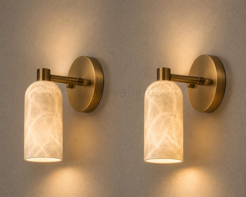 Pair of modern natural alabaster wall sconces in solid antique brass, luxury mid century wall lights for bathroom vanity, bedroom bedside, hallway and living room
Modern antique brass alabaster wall sconce pair with warm lighting for luxury bathroom vanity and bedroom decor
Handmade solid antique brass wall sconces with natural alabaster shades, modern mid century wall lighting
Luxury natural alabaster wall light pair in antique brass finish for bathroom vanity, bedside and hallway lighting