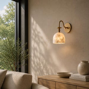 Pair of modern alabaster wall sconces with antique brass finish, handcrafted mid century bathroom vanity wall lights on a warm beige textured wall
Pair of handcrafted alabaster brass wall lights, modern mid century wall sconces for bathroom, bedroom, or entryway
Modern brass wall sconce pair with natural alabaster shades, elegant luxury bathroom vanity lighting fixture
Antique brass alabaster wall light fixture, handmade modern wall sconces with warm illumination for luxury interiors