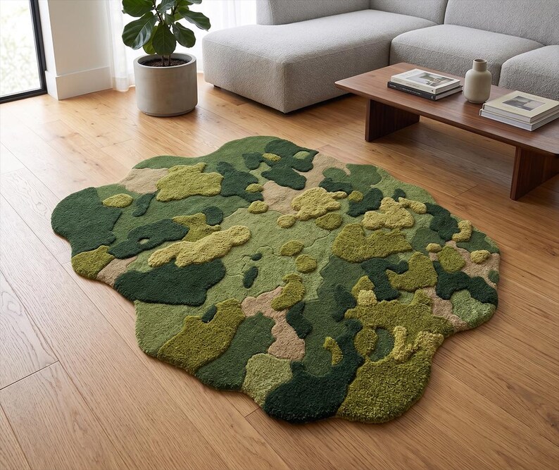 May include: A unique, irregularly shaped rug with a camouflage pattern in shades of green, tan, and olive. The rug is placed on a hardwood floor, adding a touch of nature-inspired design to the room. The rug's texture and color palette create a visually interesting focal point.