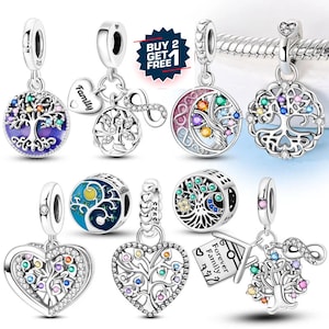 May include: A collection of silver charm pendants with various designs, including trees, hearts, and infinity symbols. Some charms feature colorful gemstones and enamel details. The image includes a "Buy 2 Get 1 Free" promotion.