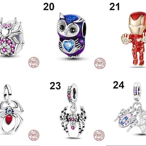 May include: A collection of six sterling silver charms featuring various designs: a spider with pink and clear stones, a purple owl with a blue heart, a red and gold superhero figure, a spider with a red stone, a spider with pink stones, and a spider web charm.