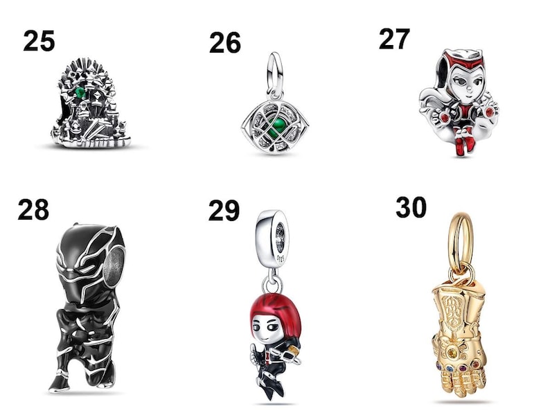 May include: A collection of six silver and gold-toned metal charms labeled 25 through 30. The charms feature various character designs including a throne, an eye, a red-clad figure, a black masked figure, a red-haired figure, and a golden gauntlet.