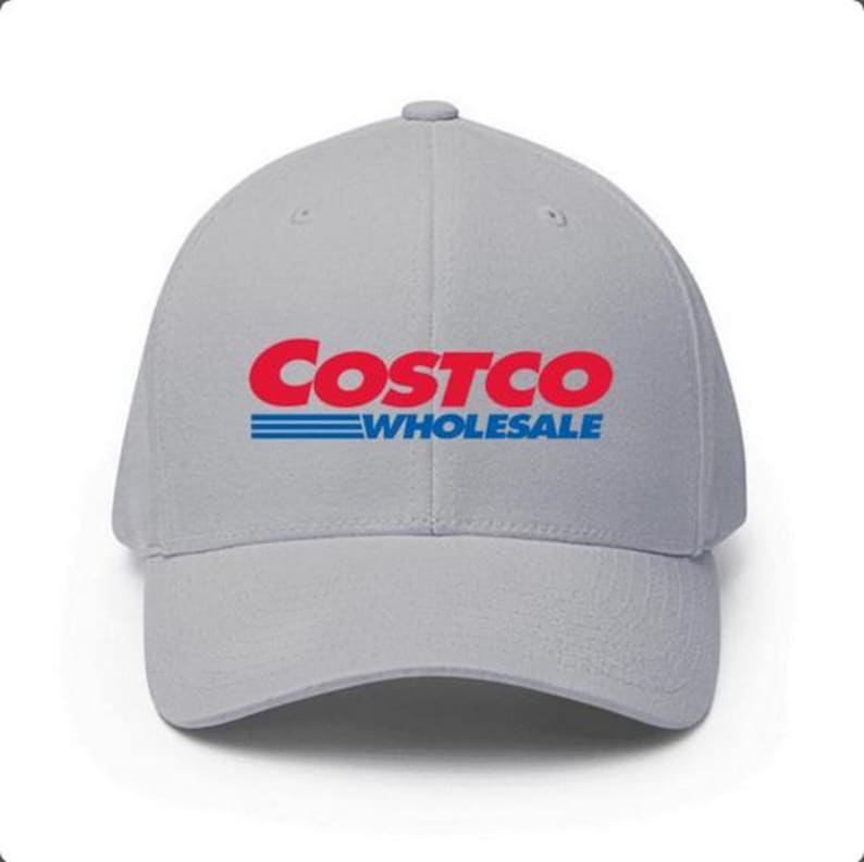 May include: A light gray baseball cap featuring the Costco Wholesale logo in red and blue. The logo is prominently displayed on the front of the cap. The cap has a curved brim and a structured fit.